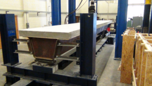 Testing of a composite press-brake tub girder at West Virginia University, part of an extensive SSSBA-supported research program evaluating the strength, fatigue performance and structural behavior of PBTGs for short-span bridge applications.