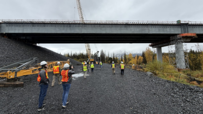 Meeting attendees get an up-close look at construction of the Juneau Creek Bridge, which includes approximately 6.75 million pounds of structural steel, during a site tour hosted by Alaska DOT&PF.