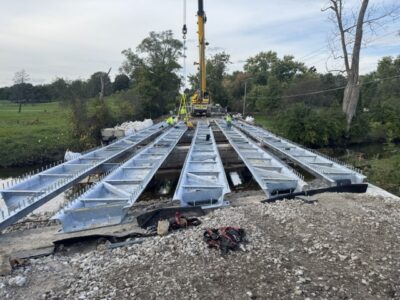 Installation of 15 galvanized, 12-inch-deep press-brake tub girders for the three-span Smith Road Bridge replacement over Long Run Creek in Will County, Illinois.