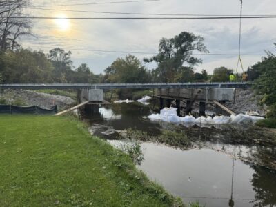 Installation of galvanized press-brake tub girders for the Smith Road Bridge in Will County, Illinois, demonstrating how their lightweight, prefabricated design allows for efficient installation and accelerated bridge construction.